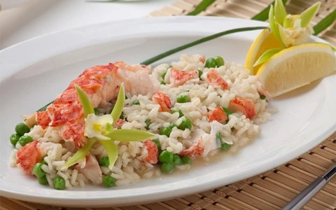 a plate of food with rice, vegetables, and seafood