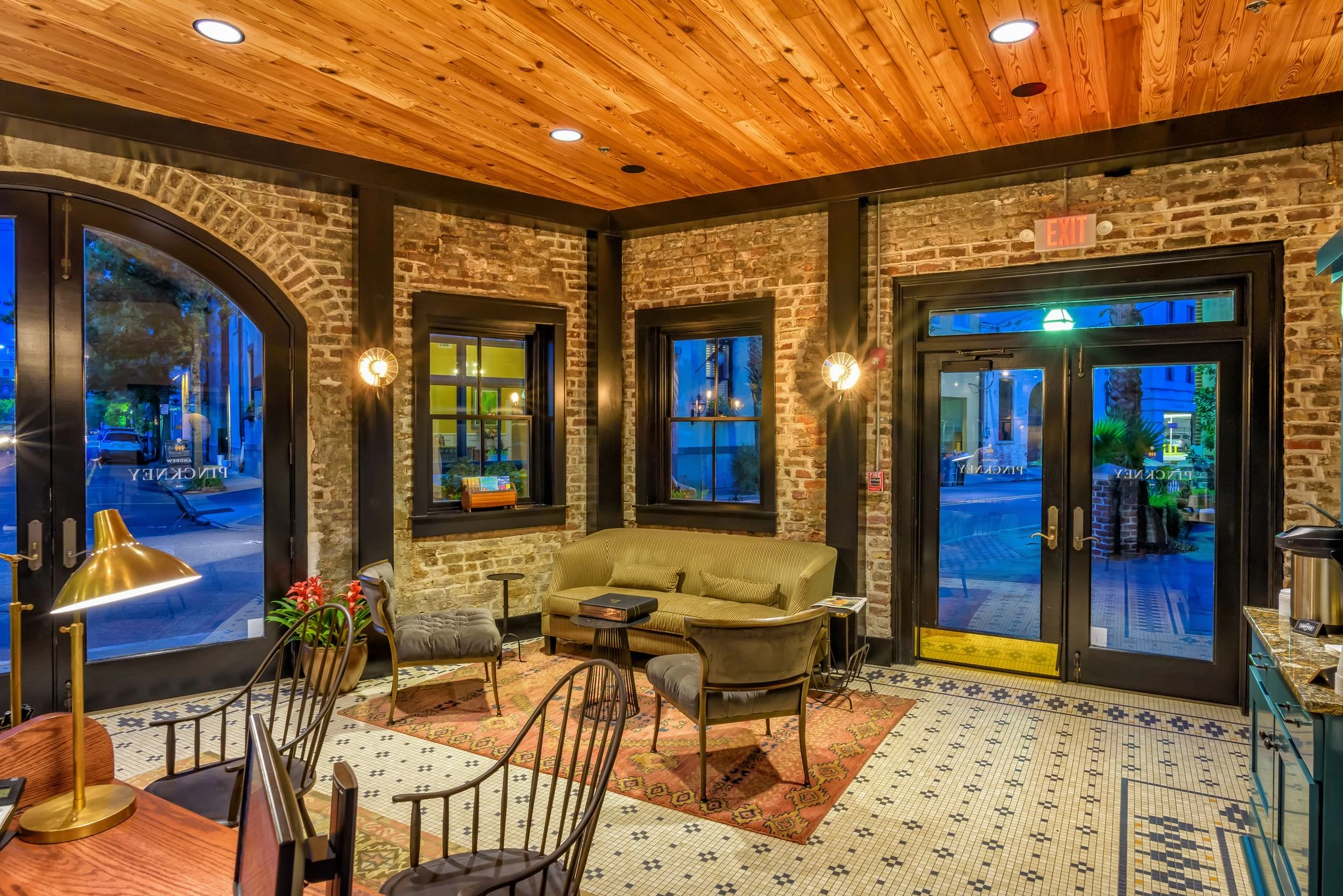 a room with a brick wall and chairs