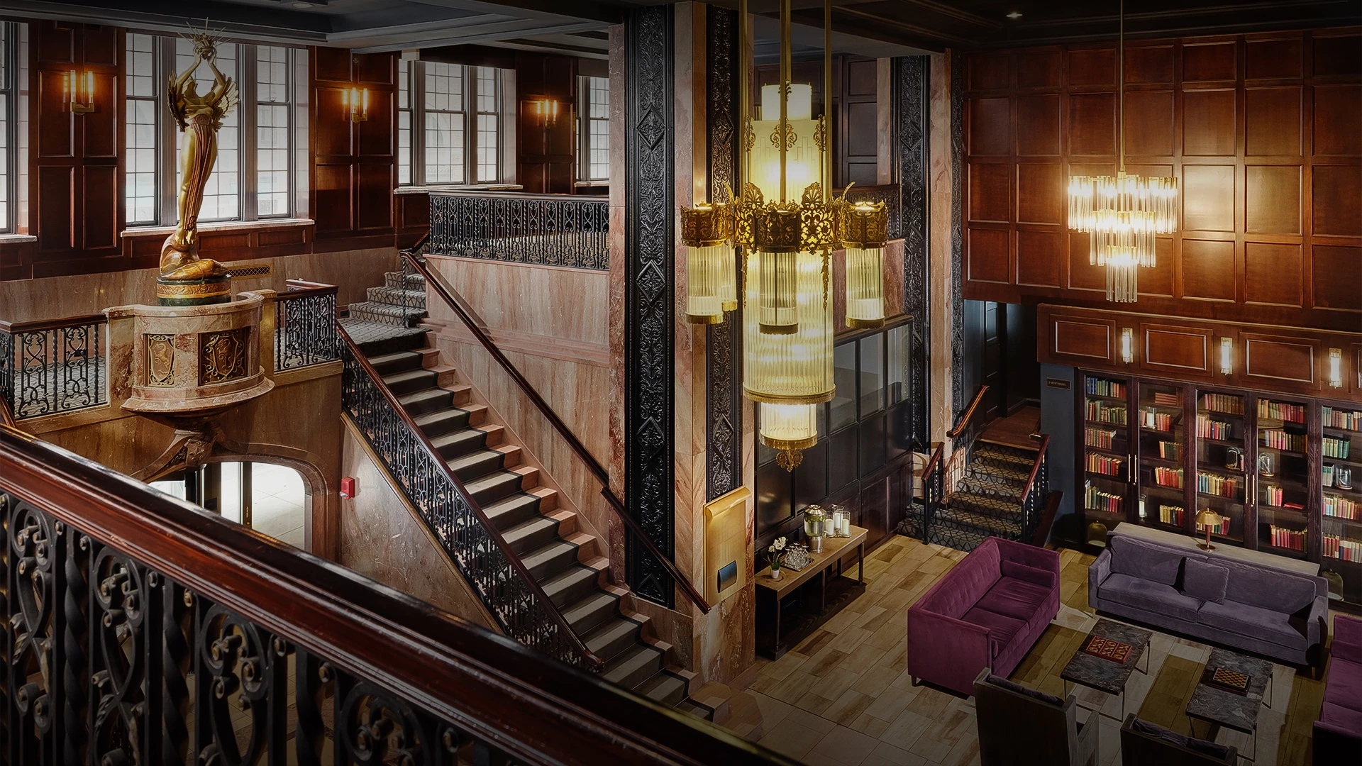 a staircase with a chandelier and a couch