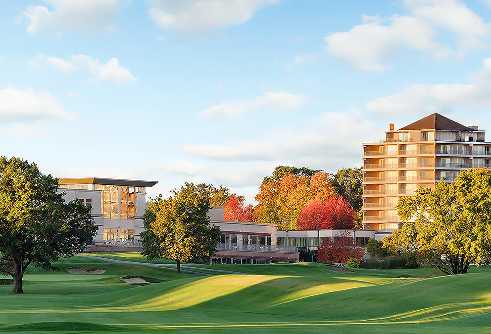 a golf course with buildings and trees