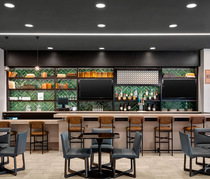 a bar with chairs and a television