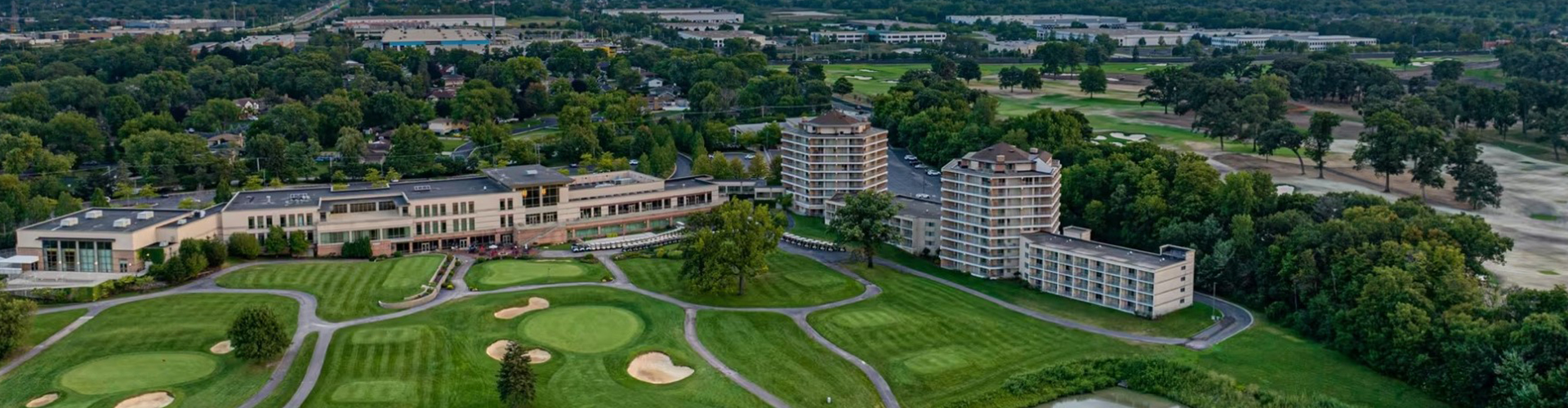 a golf course with a golf course and buildings