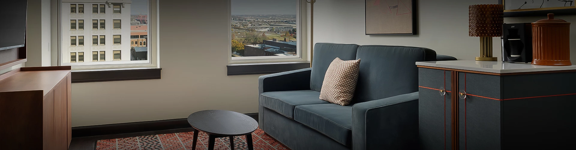 a couch and a table in front of a window