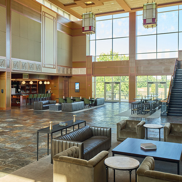 a large room with a large staircase and couches