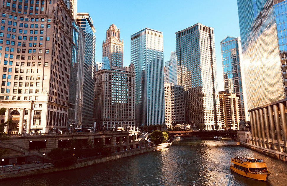 a river with a city skyline and a boat