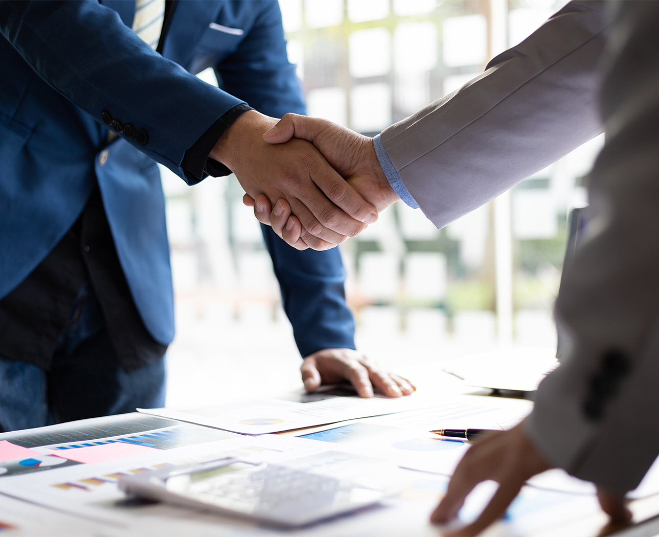 a close-up of people shaking hands