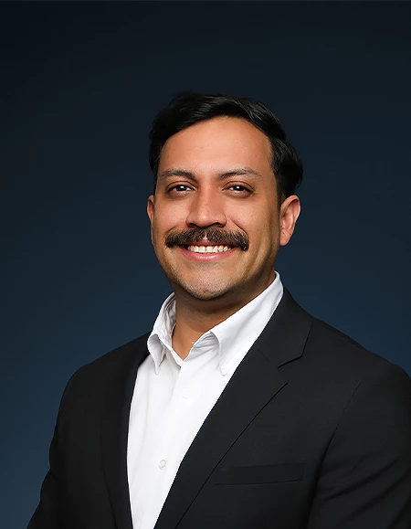 a man with a mustache smiling