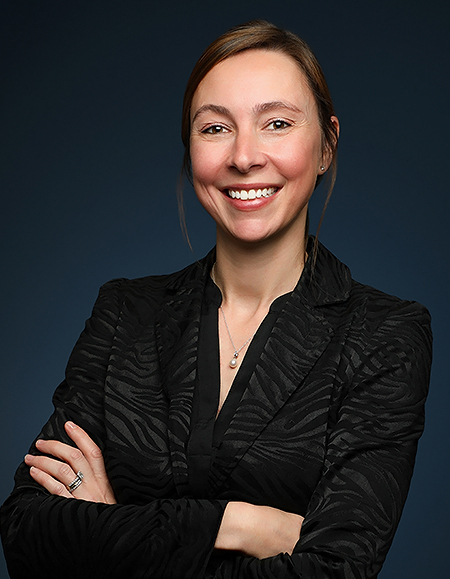 a woman smiling with her arms crossed