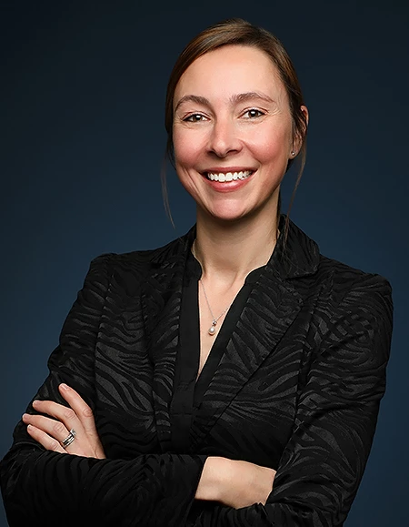a woman smiling with her arms crossed