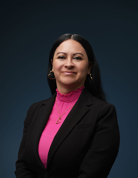 a woman in a pink shirt and black jacket
