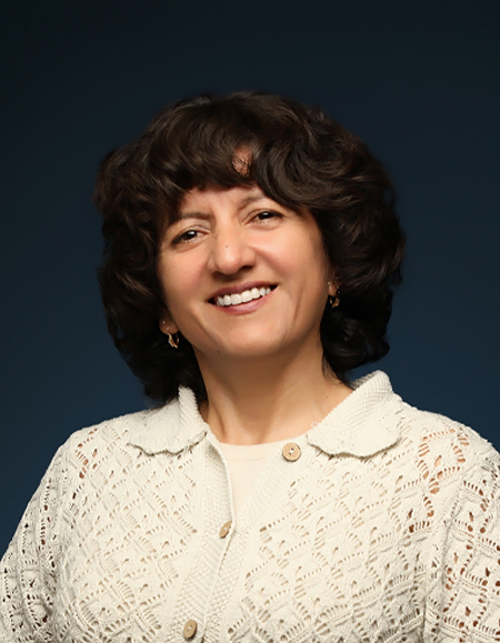 a woman with curly hair smiling