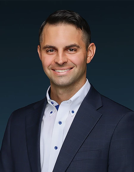 a man in a suit smiling