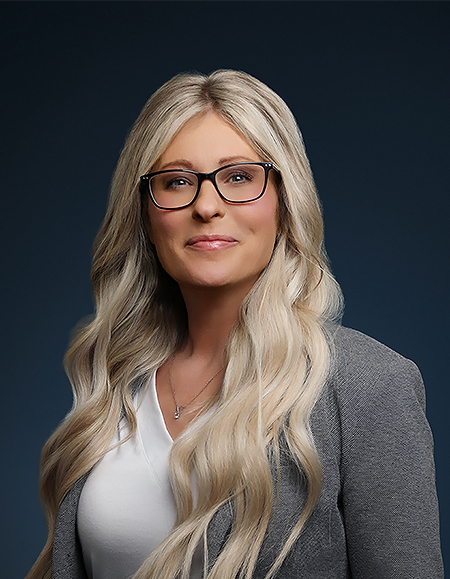 a woman with long blonde hair wearing glasses