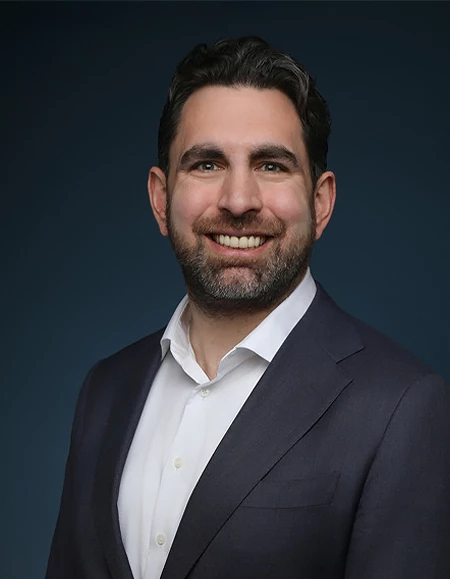 a man in a suit smiling