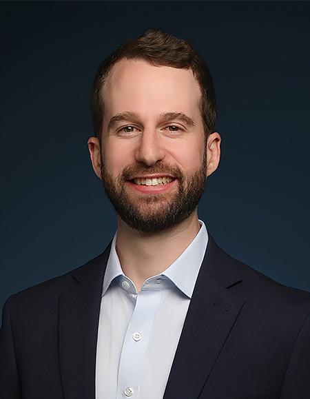 a man in a suit smiling