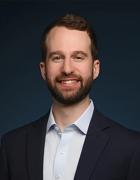 a man in a suit smiling