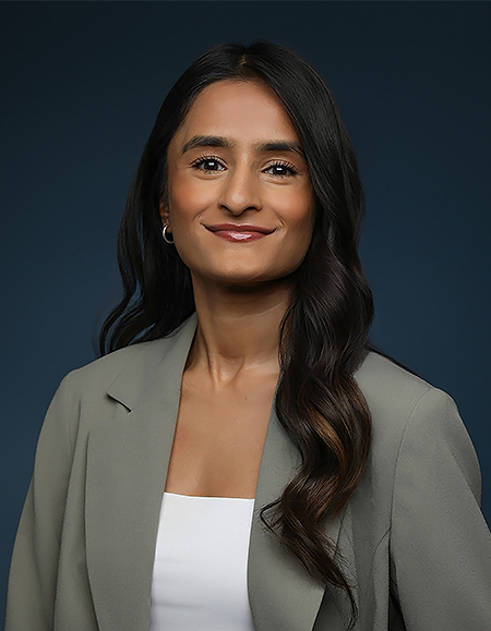 a woman with long hair wearing a suit jacket