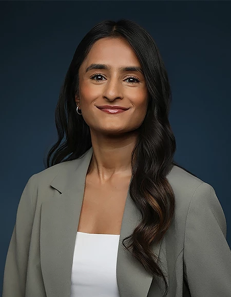 a woman with long hair wearing a suit jacket