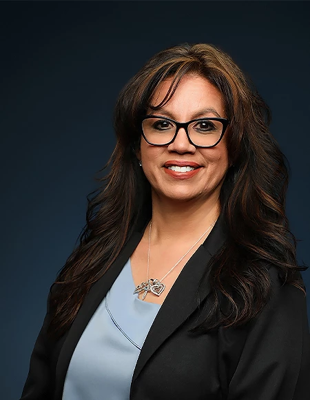 a woman wearing glasses and a black jacket