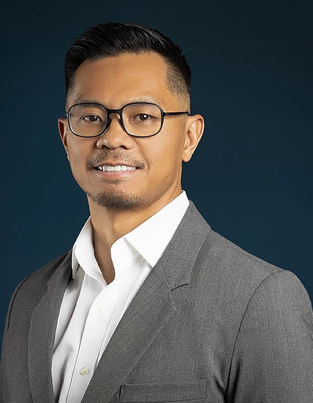 a man in a suit and glasses