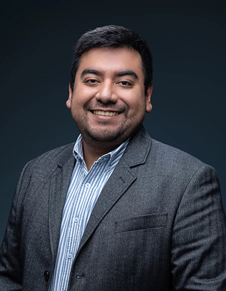 a man in a suit smiling