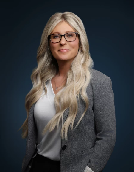 a woman with long blonde hair wearing glasses