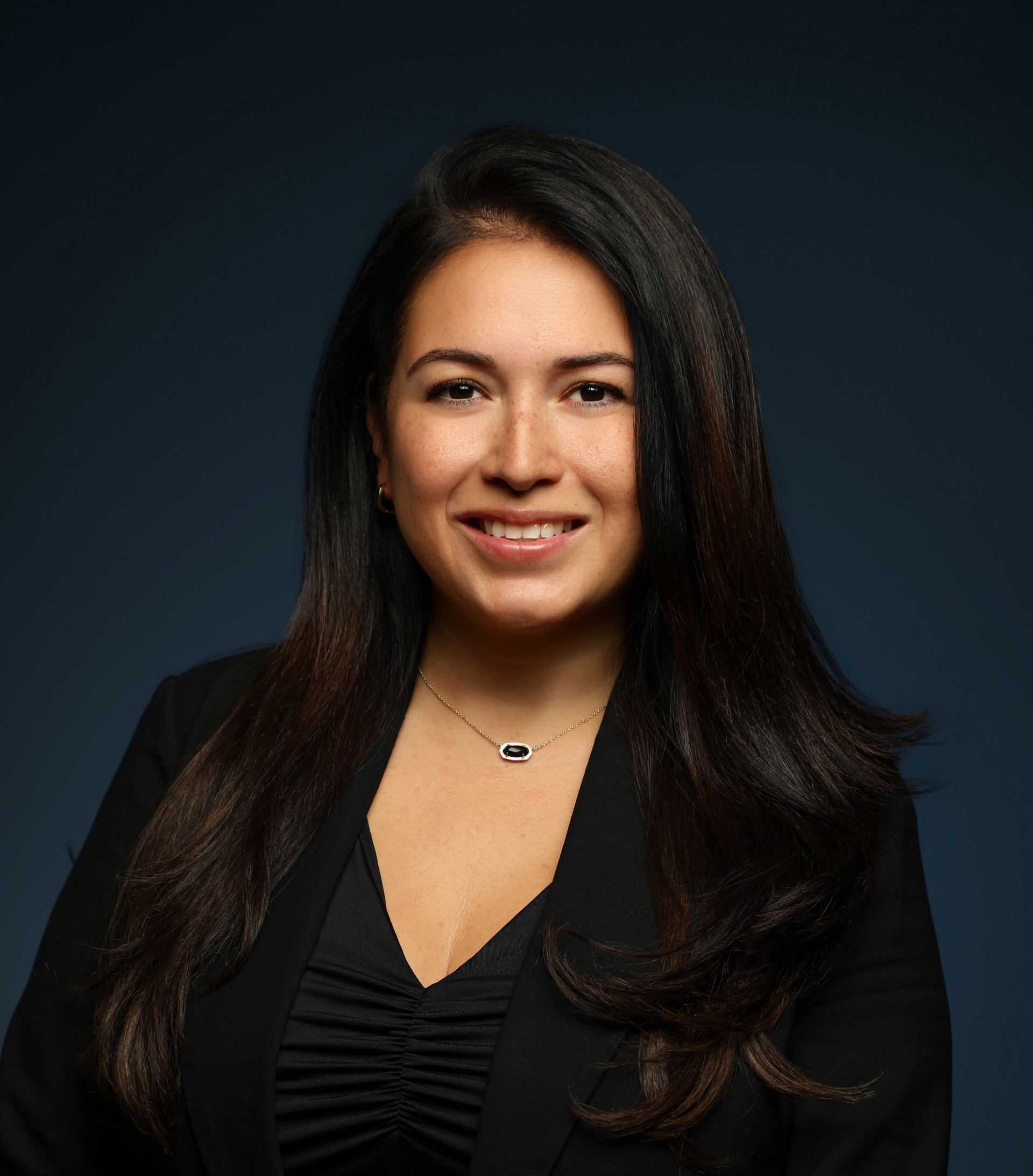 a woman with long hair wearing a black jacket