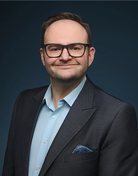a man in a suit and glasses