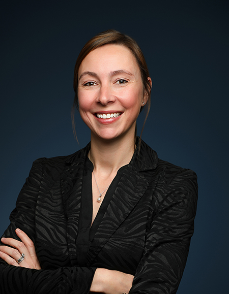 a woman smiling with her arms crossed
