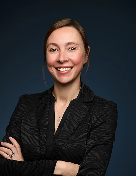 a woman smiling with her arms crossed