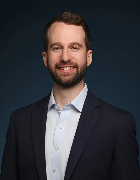 a man in a suit smiling