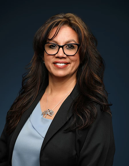a woman wearing glasses and a black jacket