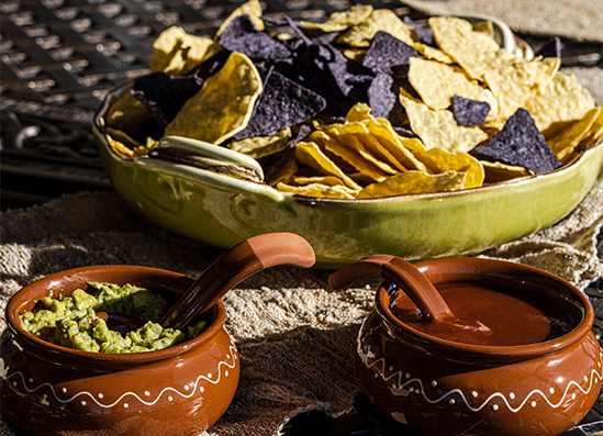 a bowl of chips and sauce