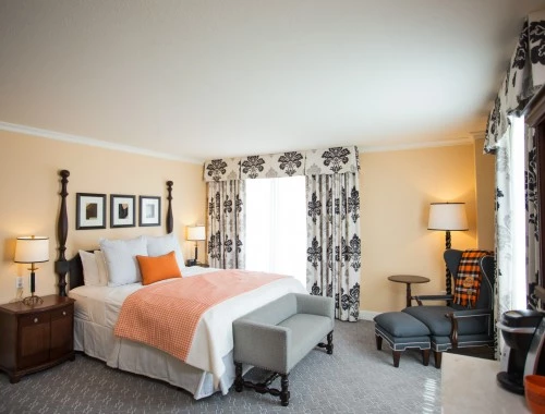 bedroom with queen bed sofa and chair