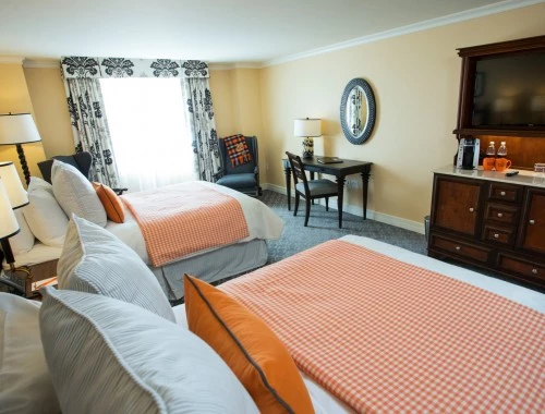 double bed room with a desk and chair with yellow walls