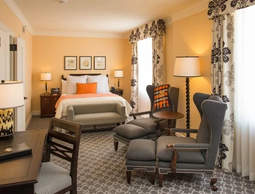 deluxe queen room with two chairs and a desk