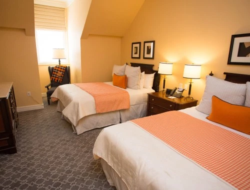 double queen bedroom with a nightstand