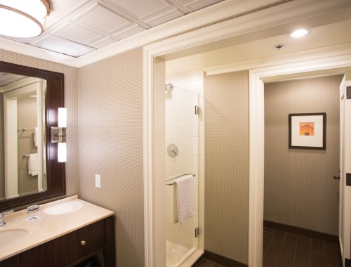 bathroom with walk in shower and towel rack