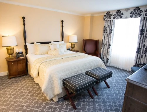 king bed with dark furniture and seating