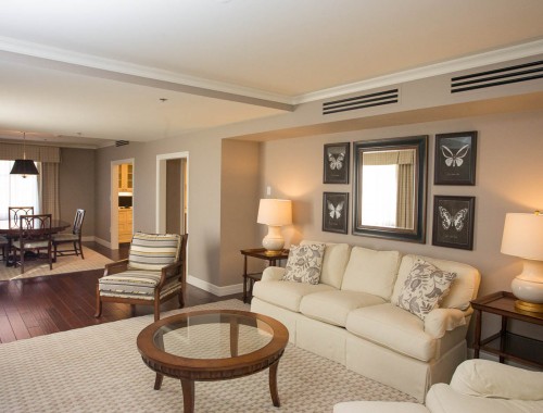 living room with white couches and dim lighting