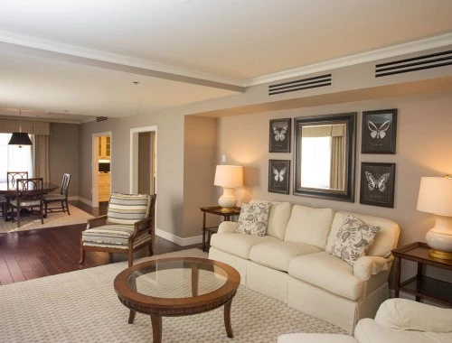 living room with white couches and dim lighting