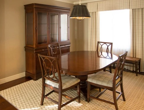 dining area with four chairs and a cabinet next to it