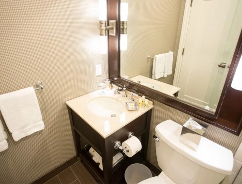 aerial view of the bathroom with dark cabinets