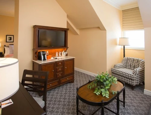 living room with cabinet with a coffee maker and desk