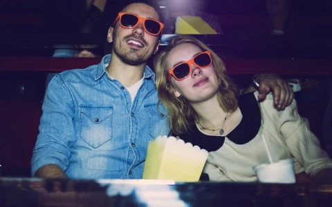 couple in orange glasses at movie theater