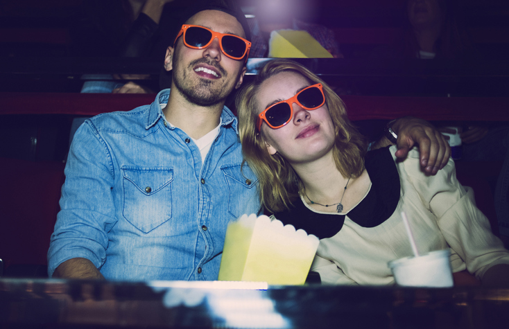 couple in orange glasses at movie theater