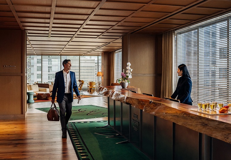 a man and woman walking in a hotel lobby