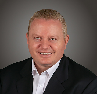 a man in a suit smiling
