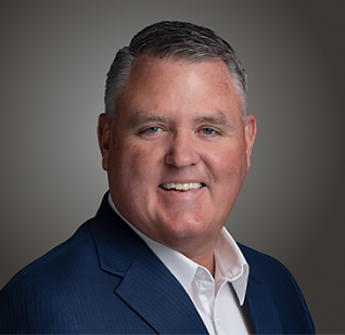 a man in a suit smiling