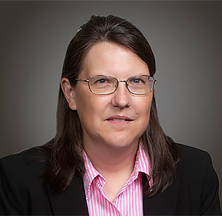 a woman wearing glasses and a suit